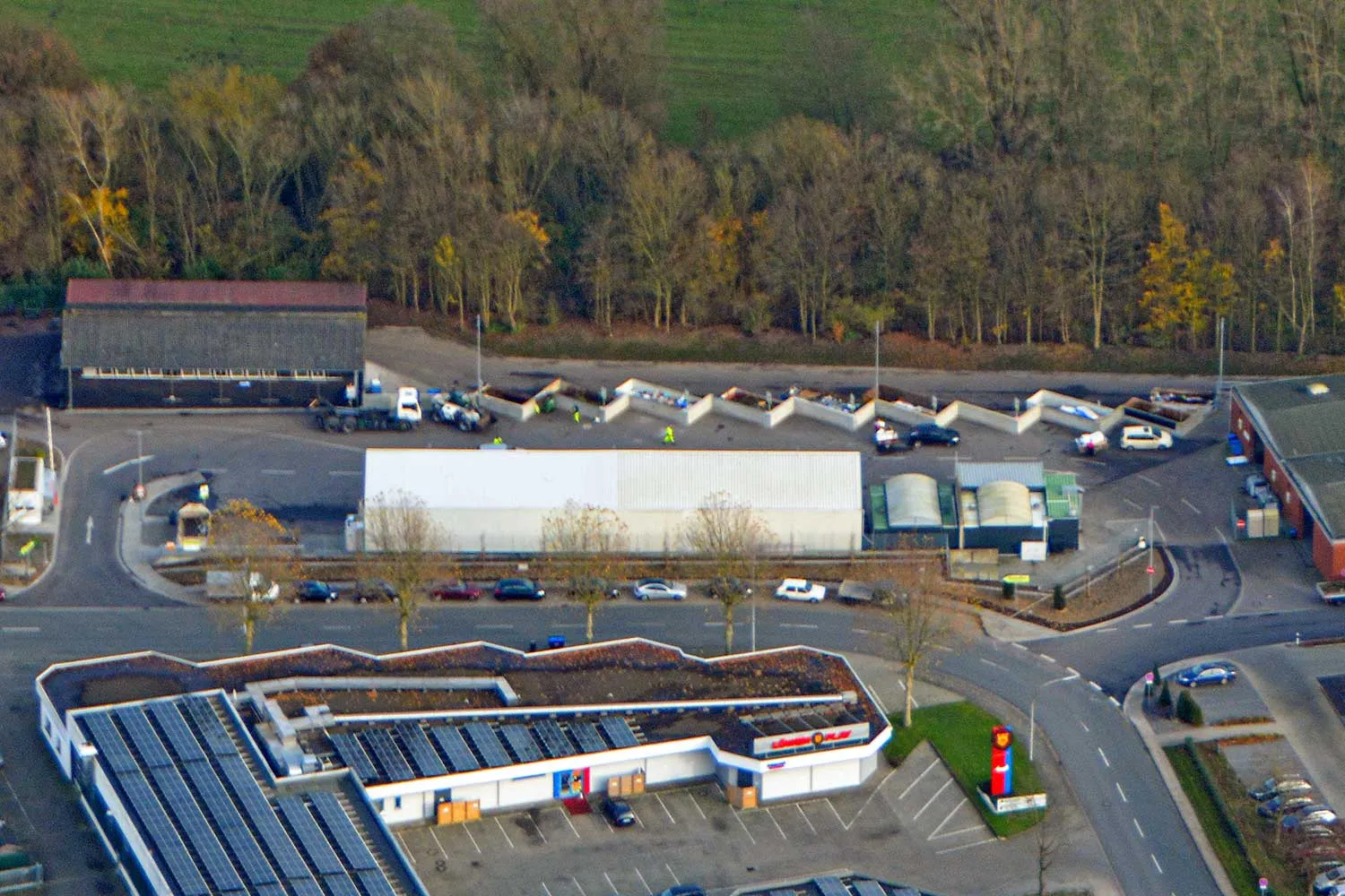 Luftaufnahme eines Wertstoffhofs mit Containern, Anlieferungsbereichen und Erschließungsstraße.